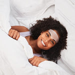 Model in bed, wearing anti wrinkle patches